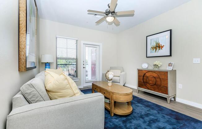 a living room filled with furniture and a large window