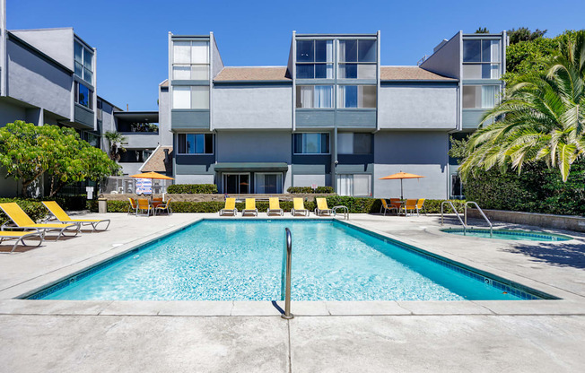 a swimming pool in front of an apartment building