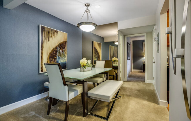 a dining room with a table and chairs