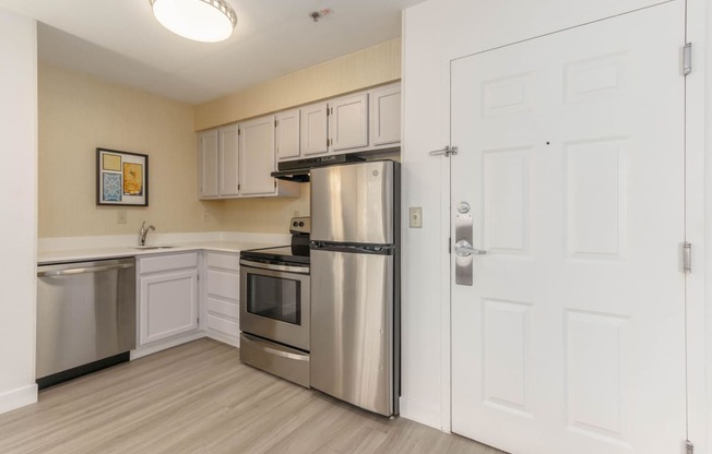 a kitchen with stainless steel appliances and white cabinets