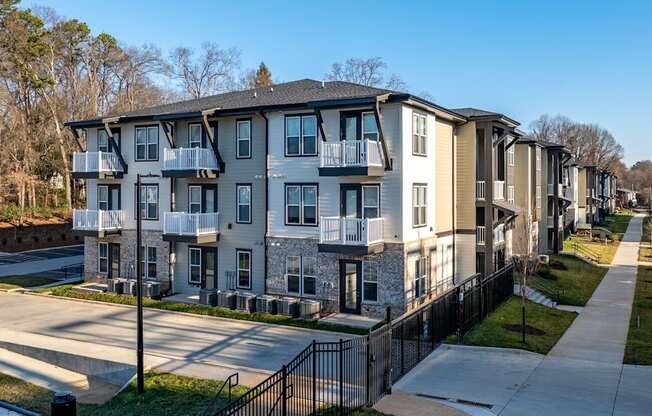 Apartment complex with a black fence in front.