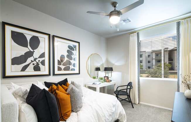 a bedroom with a large bed and a ceiling fan