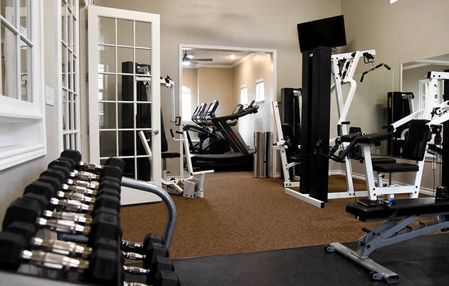 a apartment gym with weights and cardio equipment