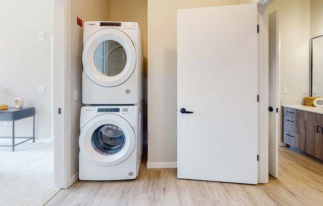 a front load washer and dryer are stacked on top of each other in a laundry