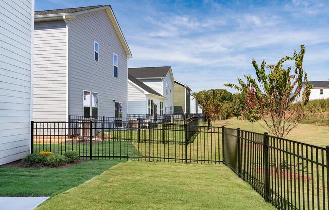 Outdoor space at Amavi Brier Creek, where fenced yards and open views complement private living in a well-connected Durham community.