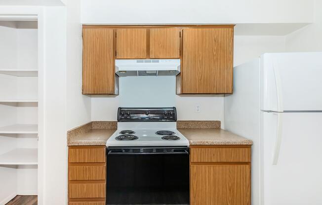 a kitchen with a stove top oven sitting inside of a refrigerator