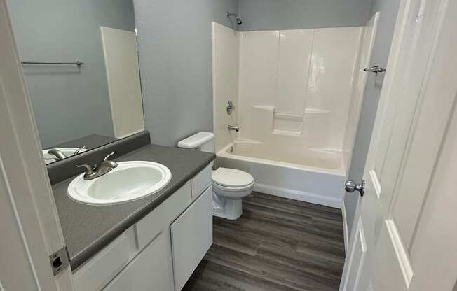 a small bathroom with a sink toilet and bathtub