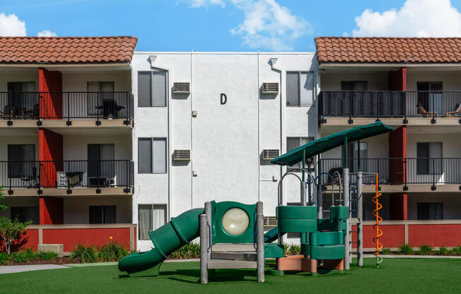 a playground in front of an apartment building