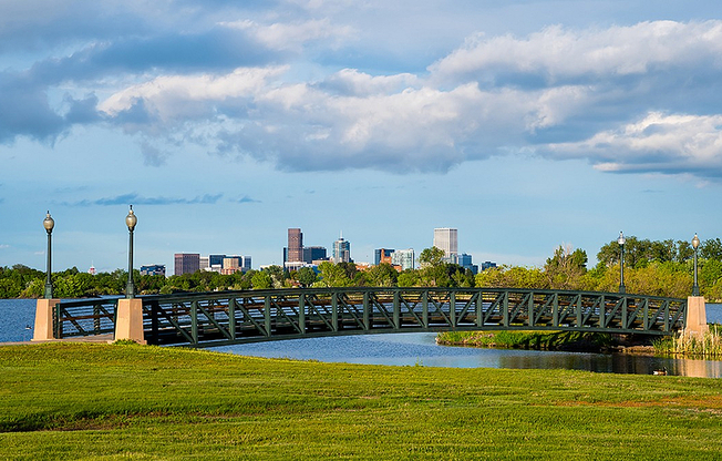 Experience urban tranquility with this stunning view of the skyline and serene river.