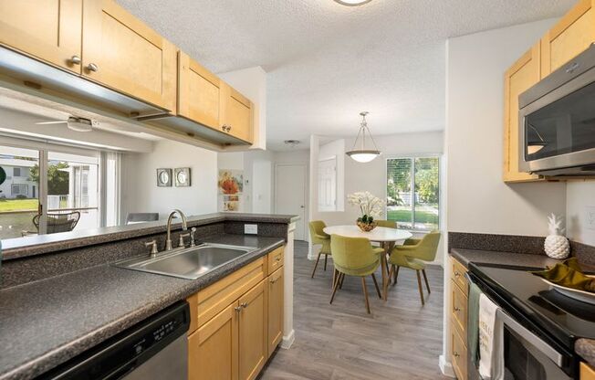 a kitchen and dining room with a sink and a table