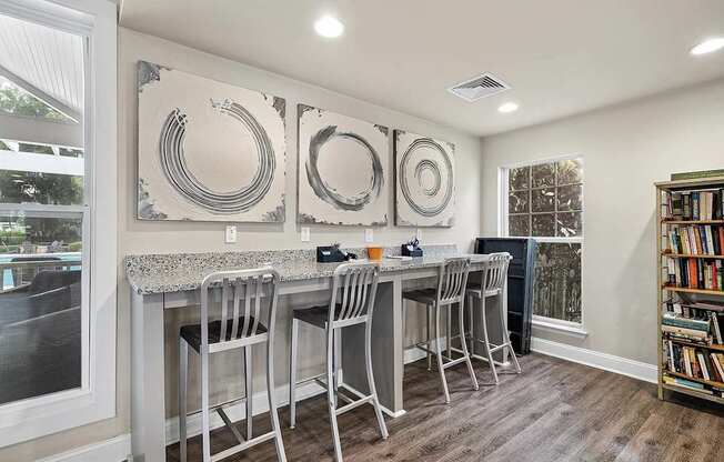 A kitchen with a bar area and a bookshelf.