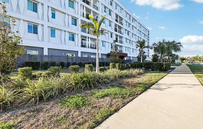A modern building with a white facade and blue sky in the background.