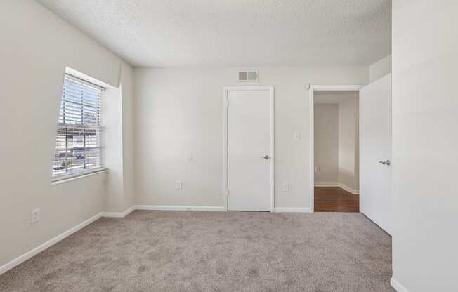 A room with a carpeted floor and white walls.