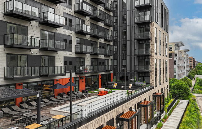 A modern apartment complex with balconies and a pool.