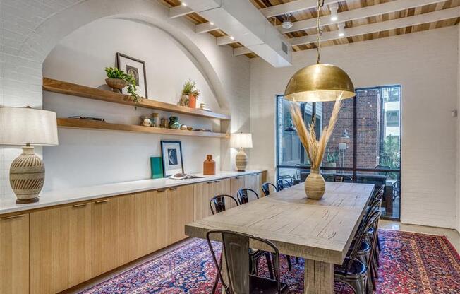 A dining room with a wooden table and chairs.