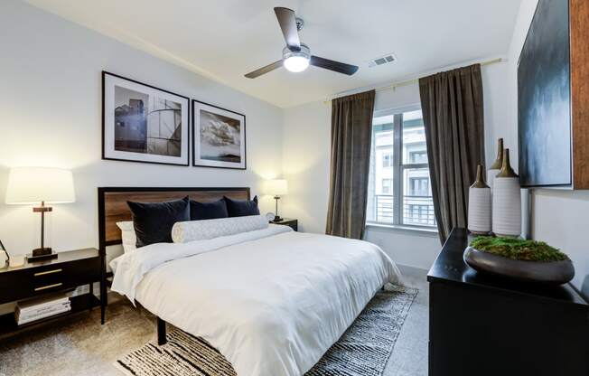 a bedroom with a large bed and a ceiling fan