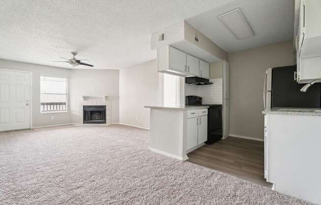 A living room with a fireplace and a ceiling fan.