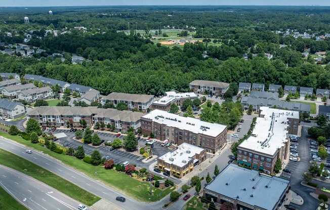 A large building complex with a parking lot in front.