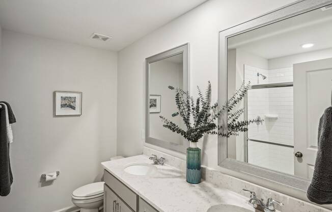 a white bathroom with a sink and a mirror