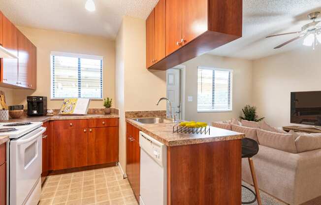 A kitchen with wooden cabinets and a white stove top oven.