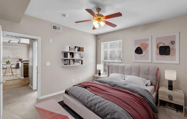 a bedroom with a bed and a ceiling fan