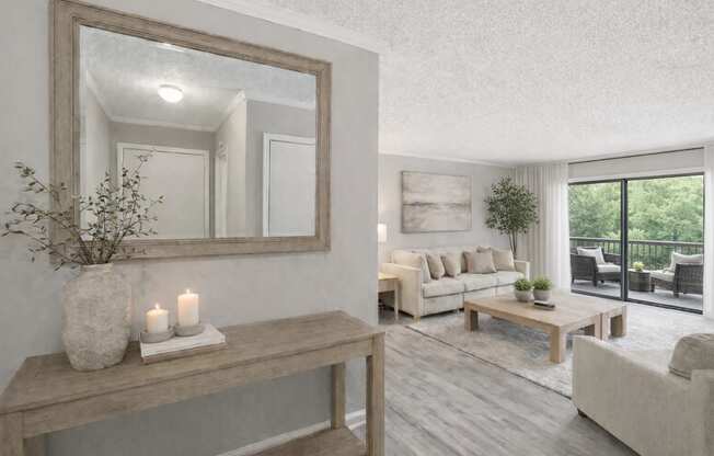 A living room with a large mirror, a wooden bench, and a vase with candles on it.