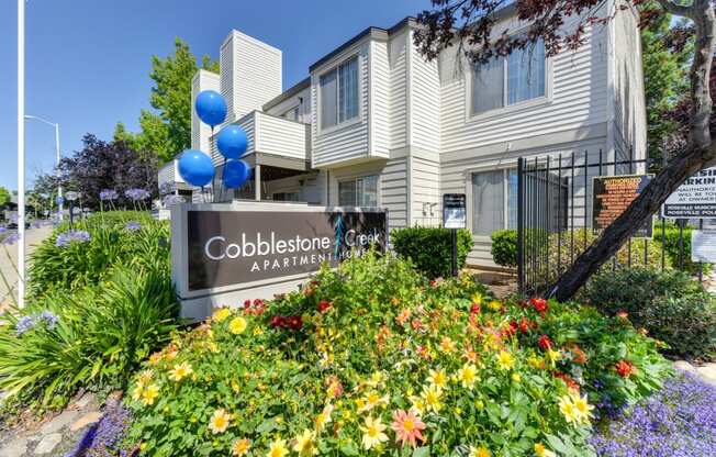 Cobblestone Creek Monument  Sign at Entrance with Flowerbed and aPARTMENT eXTERIORS 