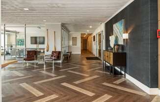 a lobby with chairs and a table and a hallway with wood floors at The Lafayette Apartments, Colonial Place, Norfolk