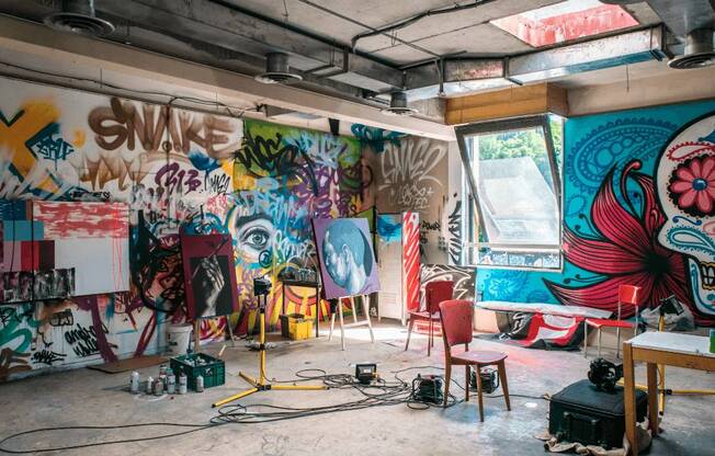 A room with graffiti on the walls and a chair in the middle at Addison on Fourth Apartments, Seattle, Washington