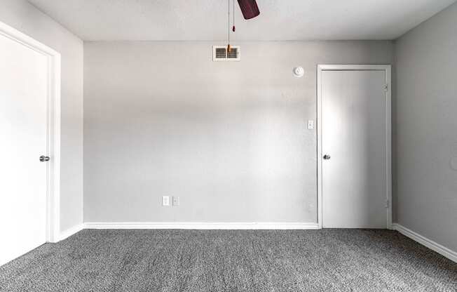 an empty room with carpet and a white door