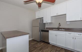 a kitchen with a sink and a refrigerator