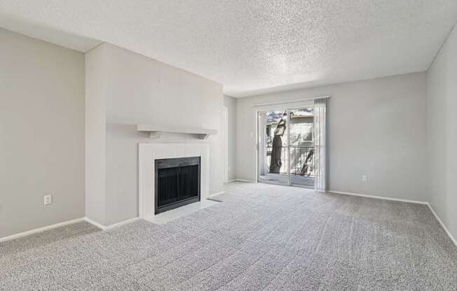 A room with a fireplace and a carpeted floor.