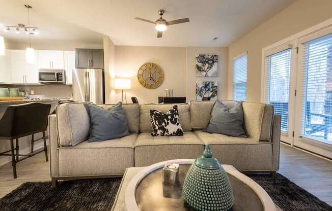 A Living Room With a Green Lamp at The Aster Apartments, North Carolina