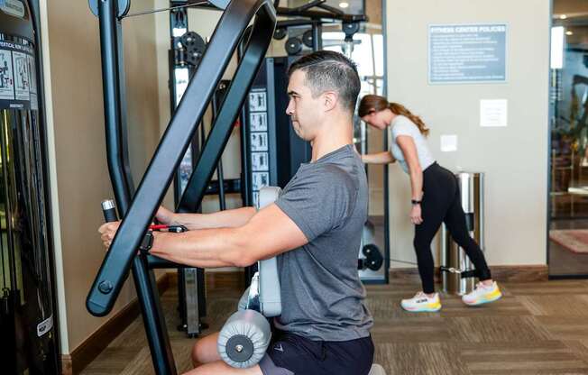 a man working out on a machine in a gym