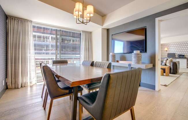 A modern dining room with a large table and chairs.