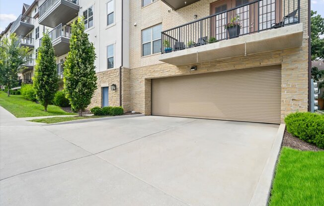 A large garage door is closed on a brick building.