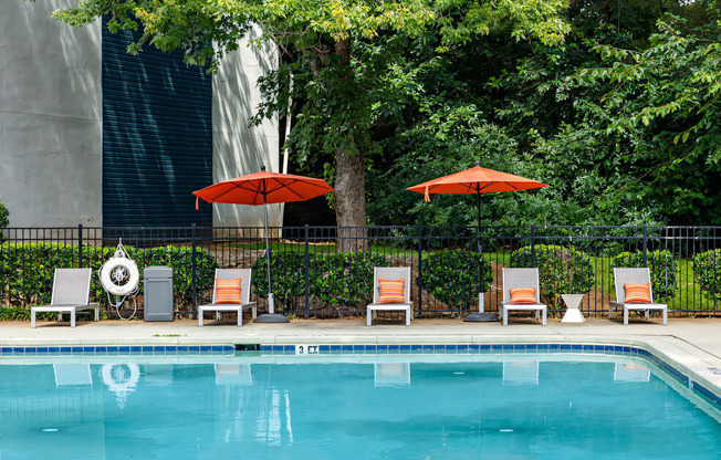 a swimming pool with chairs and umbrellas next to a resort pool at Glen Hollow, Georgia 30034
