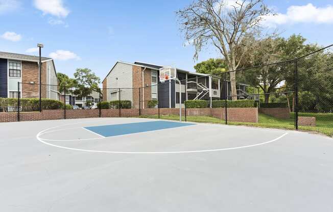 the basketball court at the whispering winds apartments in pearland tx