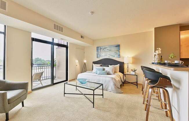 A living area with a bed, a coffee table, and a chair.