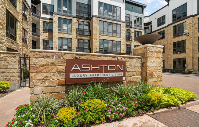 an exterior view of an apartment building with a sign luxury apartment living