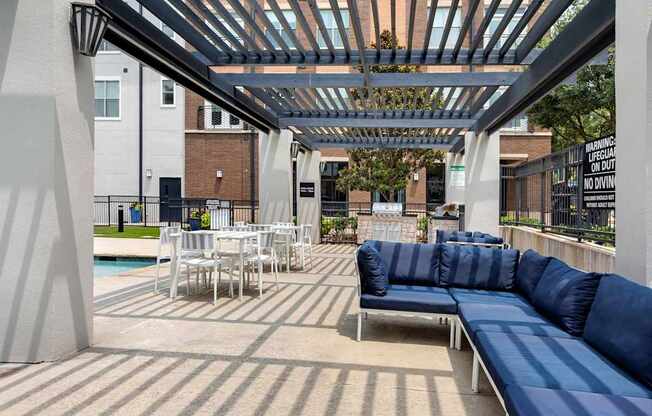 A patio with a blue couch and a pool table.