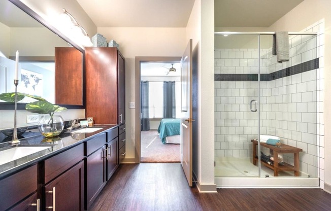 a bathroom with a walk in shower next to a sink