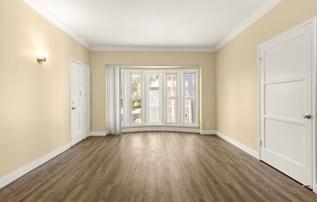 a living room with a large window and a door