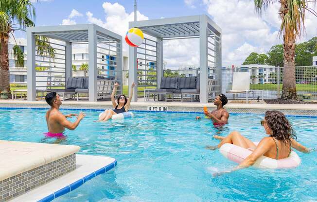 People playing in a pool with a ball.at Icon One, Daytona Beach, Florida