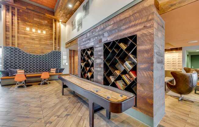 A room with a wooden floor and a bookshelf with books.