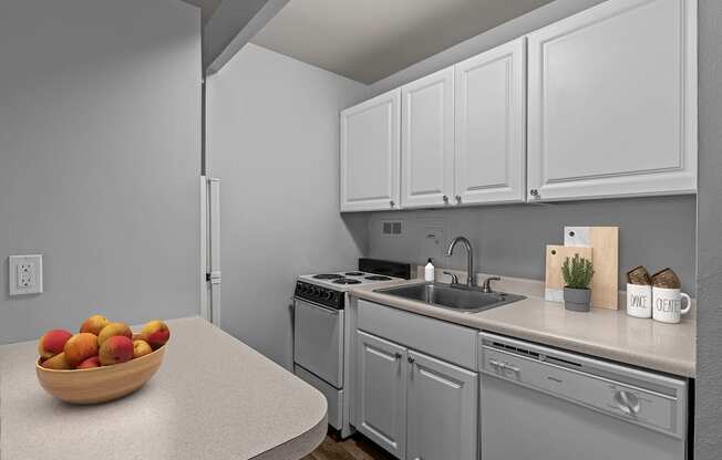 A kitchen with a bowl of fruit on the counter