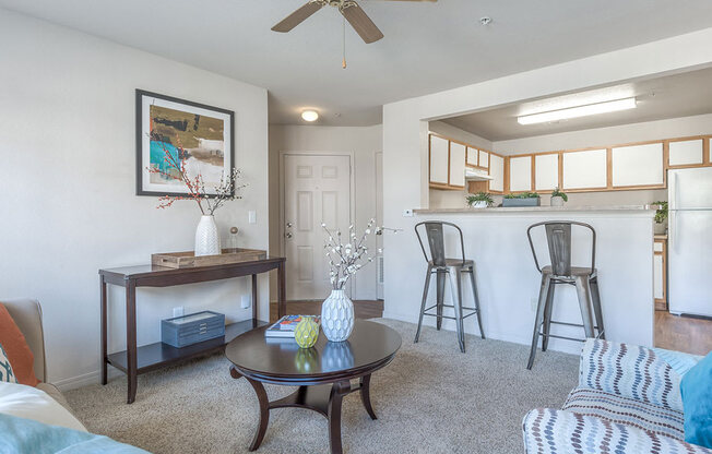 Living room with ceiling fan at Villas at Bailey Ranch Apartments, Owasso