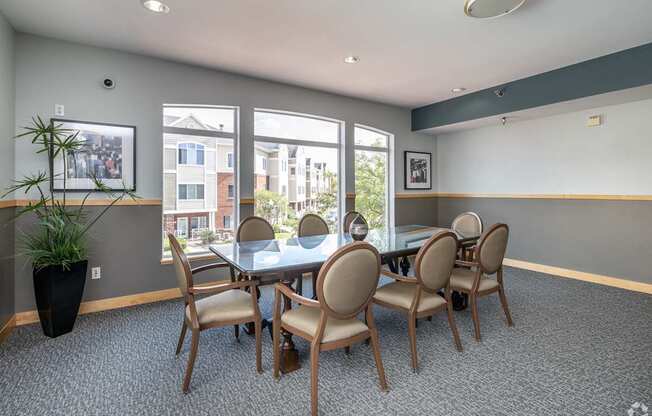 A conference room with a table and chairs.