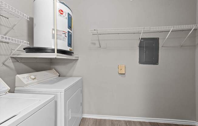 A laundry room with a washer and dryer on the shelves.