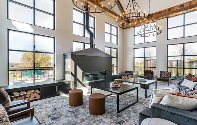 A modern living room with a fireplace and a large window.